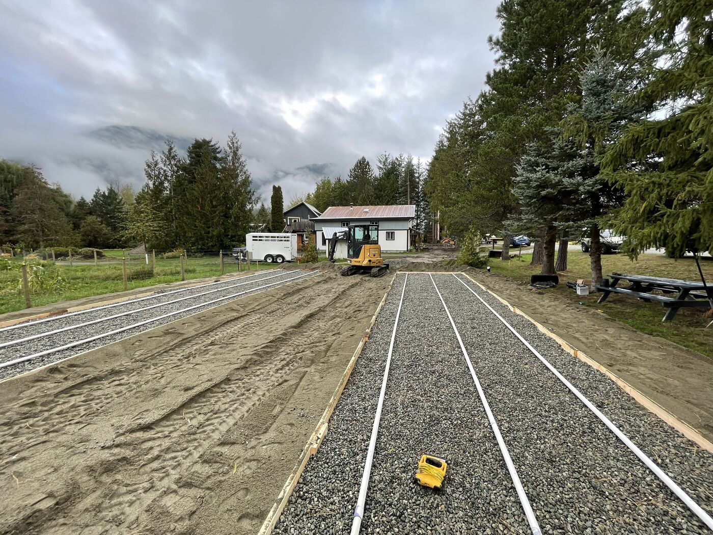 Engineered septic drain field during installation, distribution laterals laid to grade